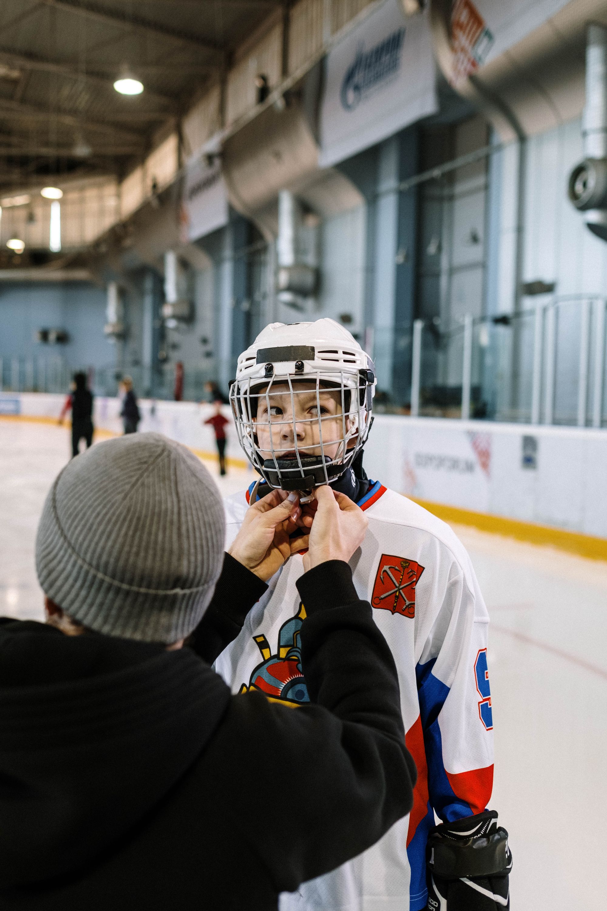 A parent and young player at the rink