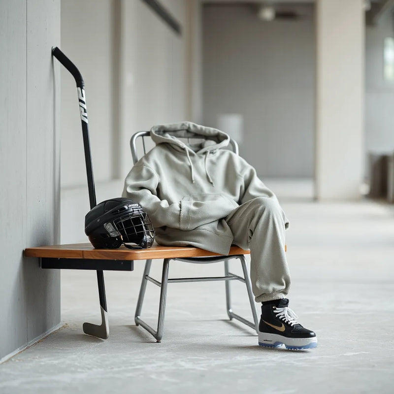 Hockey helmet, stick, and neutral streetwear laid out in a modern urban setting for everyday style