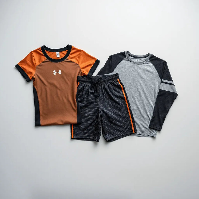Folded athletic jersey, shorts, and compression shirt with team-style printed patterns on a clean background