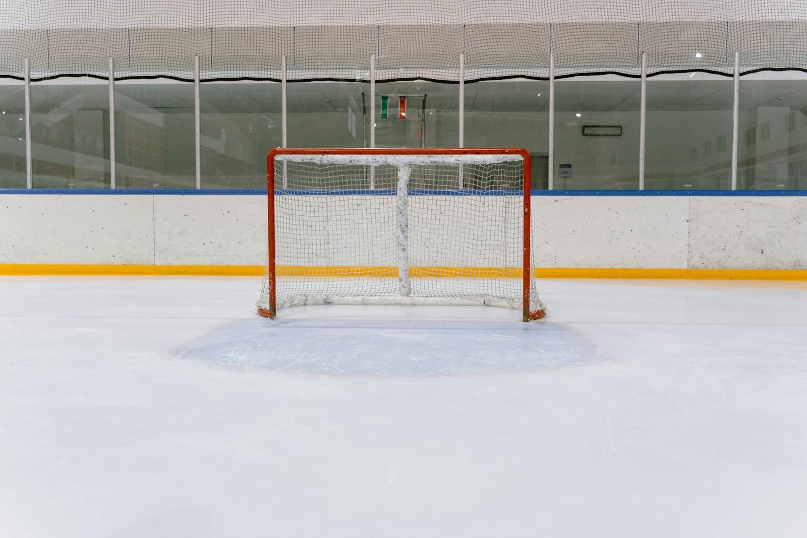 An empty hockey net on fresh ice